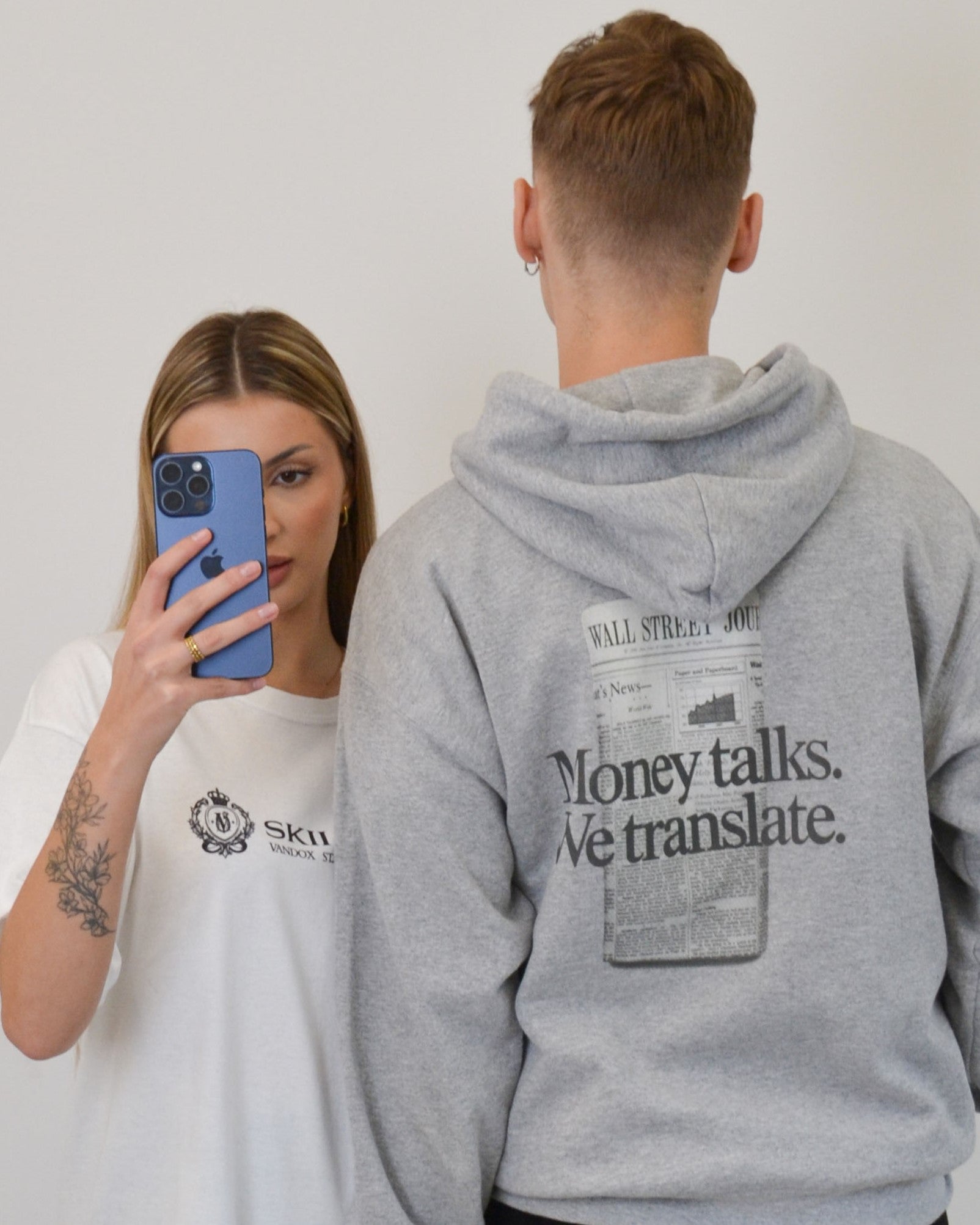 Male model wearing the Money Talks Hoodie in sport grey by Vandox - a premium oversized hoodie featuring a bold “Money Talks. We Translate.” print inspired by Wall Street culture. Designed for the confident and ambitious, this piece blends luxury streetwear with a statement-making financial aesthetic. Starboy old money hoodie sweatshirt clothes vandox sacrevandox vandox clothes vandox clothing