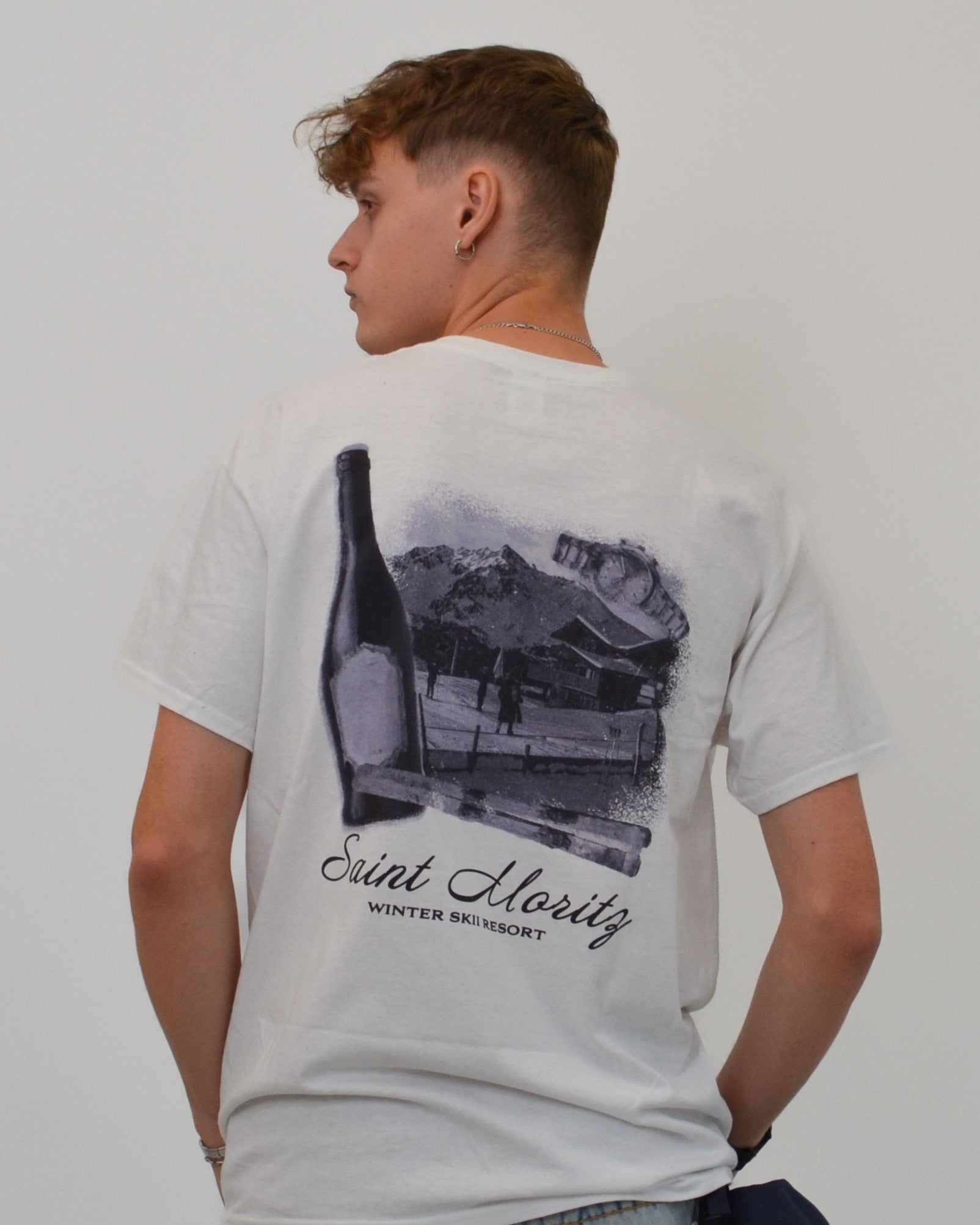 Male model wearing the Alpine Ski Club T-Shirt in white - a premium oversized tee featuring the “Saint Moritz Winter Ski Resort” print. A signature Vandox design inspired by alpine luxury and vintage ski culture, blending timeless resort elegance with contemporary streetwear minimalism. Starboy old money shirt tshirt clothes vandox sacrevandox vandox clothes vandox clothing