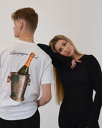 Male model wearing the Bubbly Society T-Shirt by Vandox - a premium white oversized tee featuring an elegant champagne bucket print and cursive “Champagne Club” script. A refined statement piece blending old-money sophistication with contemporary streetwear luxury.  Starboy old money shirt tshirt clothes vandox sacrevandox vandox clothes vandox clothing