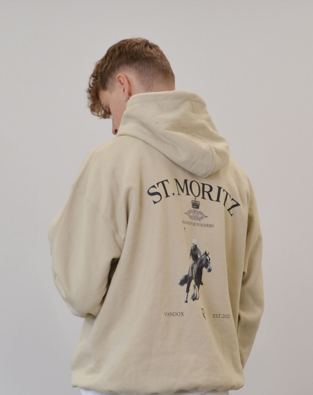 Male model wearing the Polo Club Hoodie in sand by Vandox - a premium oversized hoodie featuring a St. Moritz polo graphic with “Made for Winners” detail. The soft beige tone and luxury equestrian design capture Vandox’s refined fusion of timeless elegance and modern streetwear sophistication. Starboy old money hoodie sweatshirt clothes vandox sacrevandox vandox clothes vandox clothing