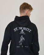Male model wearing the Polo Club Hoodie in black by Vandox - a luxury oversized hoodie featuring a bold “St. Moritz” graphic and a polo player motif. Designed for those who embody confidence and sophistication, this piece merges elite sport heritage with refined streetwear aesthetics. Starboy old money hoodie sweatshirt clothes vandox sacrevandox vandox clothes vandox clothing