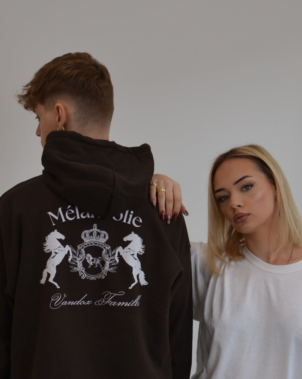 Models wearing the Mélancolie Hoodie in dark chocolate by Vandox - a premium oversized hoodie featuring the signature Vandox Famille crest. A bold yet refined piece blending vintage luxury with modern minimalism. Starboy old money hoodie sweatshirt clothes vandox sacrevandox vandox clothes vandox clothing