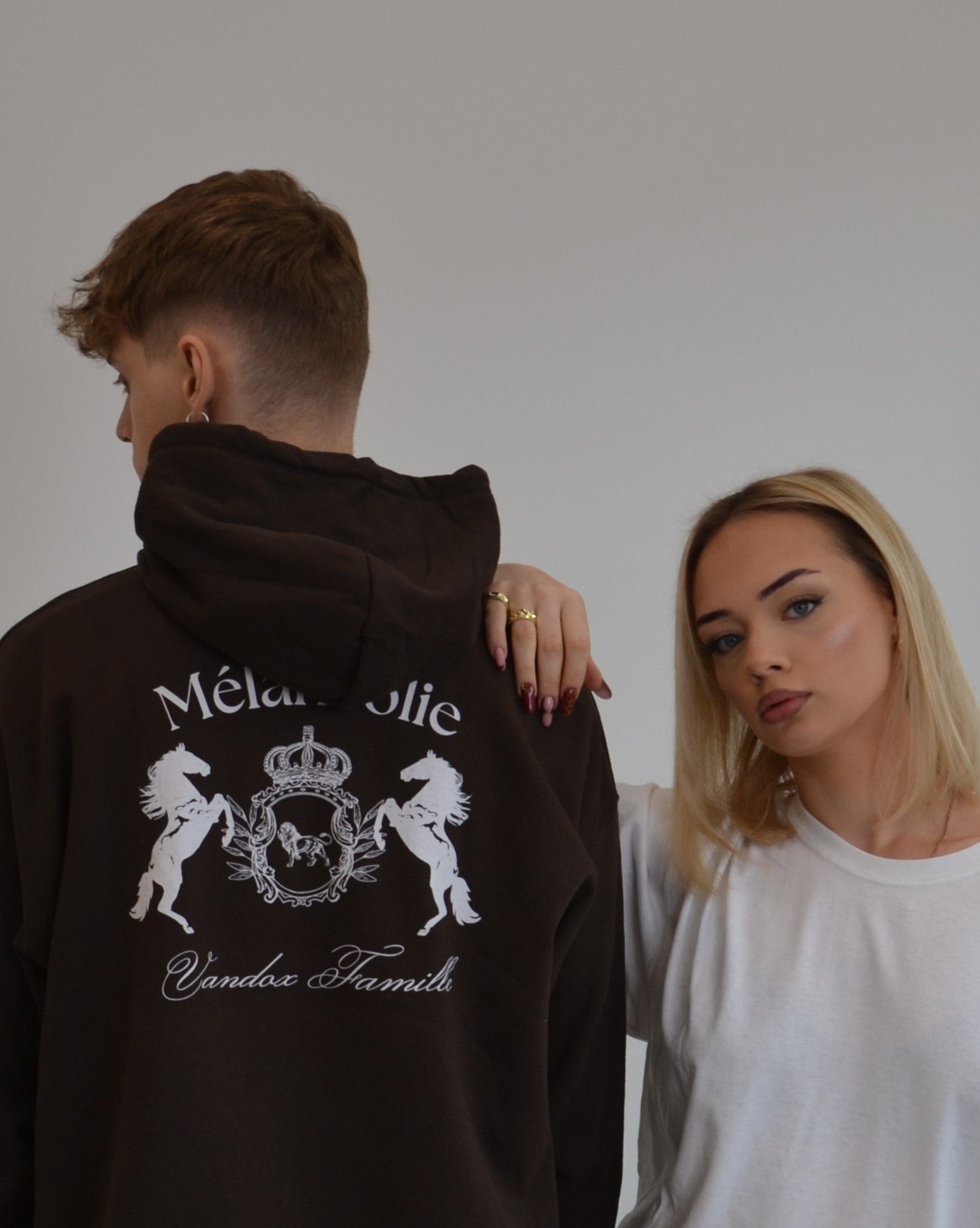 Models wearing the Mélancolie Hoodie in dark chocolate by Vandox - a premium oversized hoodie featuring the signature Vandox Famille crest. A bold yet refined piece blending vintage luxury with modern minimalism. Starboy old money hoodie sweatshirt clothes vandox sacrevandox vandox clothes vandox clothing