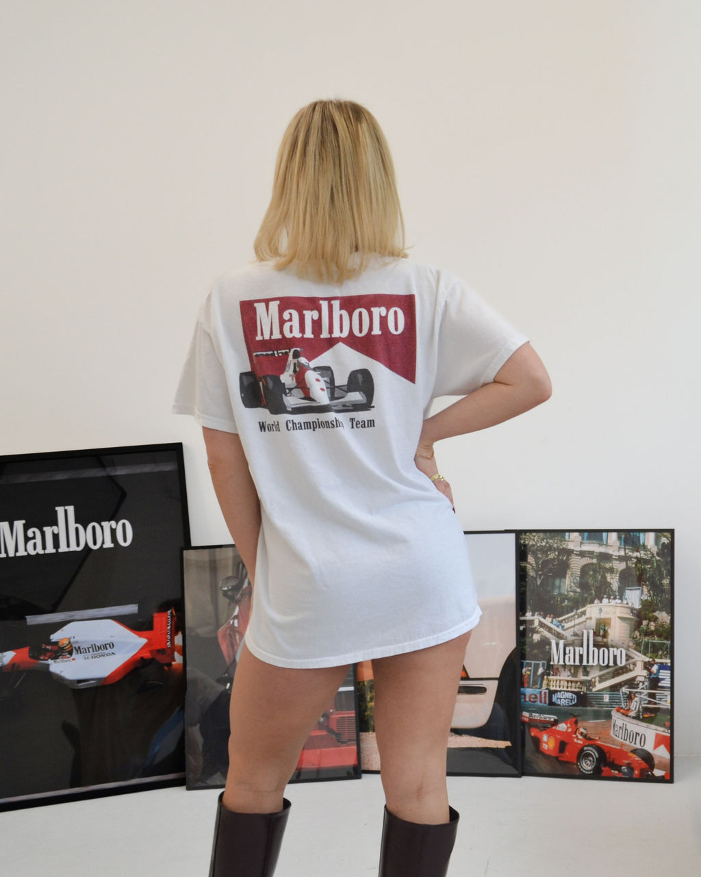 Female model wearing the Marlboro Racing T-Shirt in white - a vintage-inspired graphic tee featuring the iconic Marlboro “World Championship Team” Formula 1 car print. A bold retro design that channels 90s motorsport heritage, streetwear attitude, and timeless racing culture energy. Starboy old money shirt tshirt clothes vandox sacrevandox vandox clothes vandox clothing