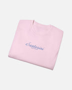 Light Pink Vandox Santorini Tee folded view – light pink premium cotton t-shirt with Santorini script and Sacre Vandox lettering, Postcards collection. Starboy old money shirt tshirt clothes vandox sacrevandox vandox clothes vandox clothing