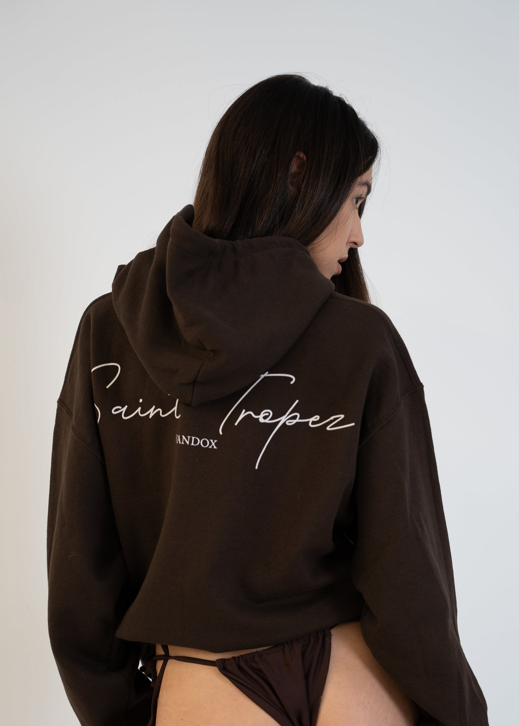 Back view of model wearing Brown Dark Chocolate Saint-Tropez Hoodie with elegant script logo print from Vandox Collection, luxury starboy old money aesthetic Vandox hoodie clothing brand