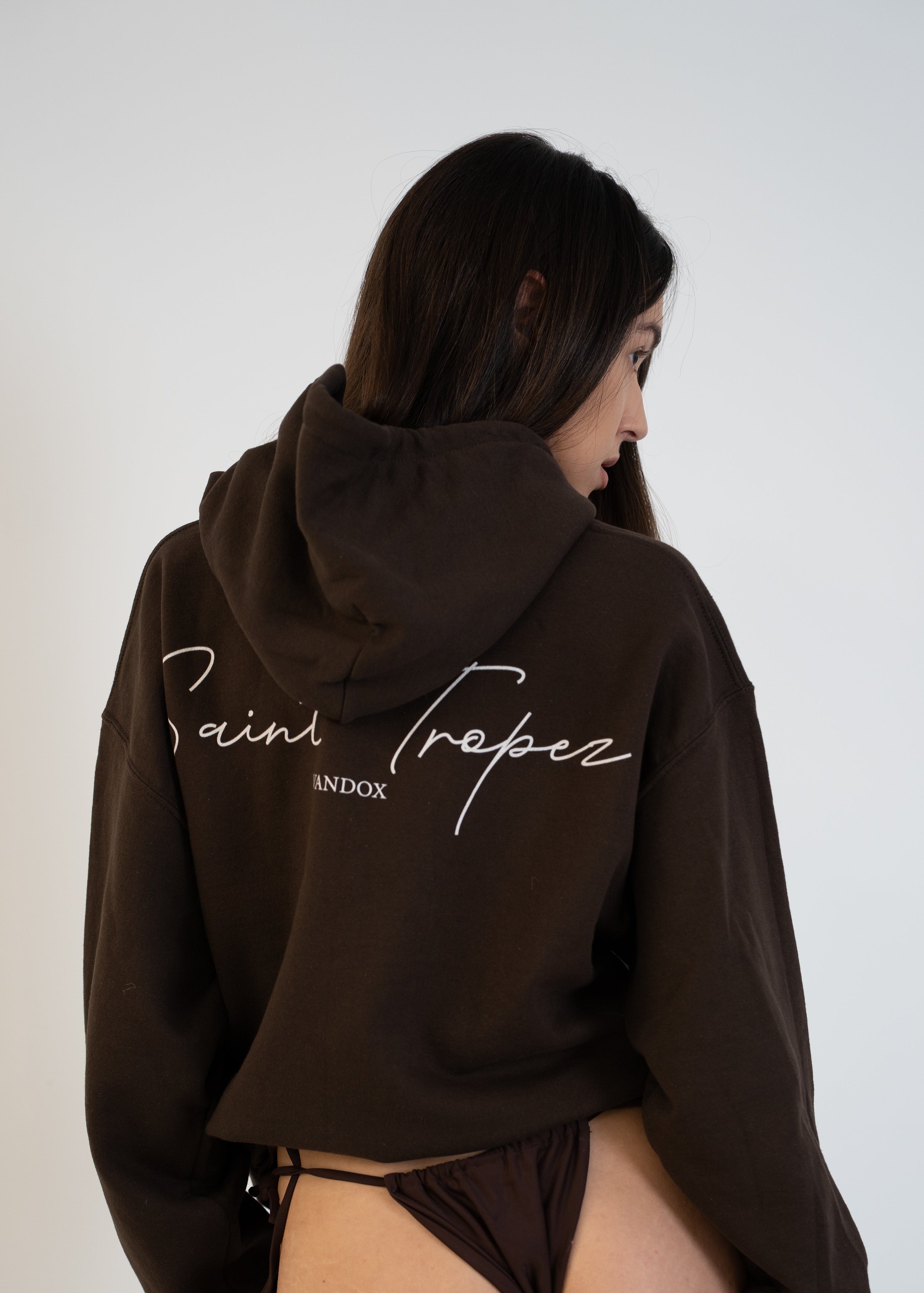 Back view of model wearing Brown Dark Chocolate Saint-Tropez Hoodie with elegant script logo print from Vandox Collection, luxury starboy old money aesthetic Vandox hoodie clothing brand