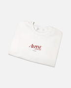 Folded view of Eggshell White Vandox Alpine Leisure crewneck sweatshirt with red Alpine Leisure Vandox chest logo. Starboy old money hoodie sweatshirt clothes vandox sacrevandox vandox clothes vandox clothing crewneck autumn clothes no hood fall clothes 