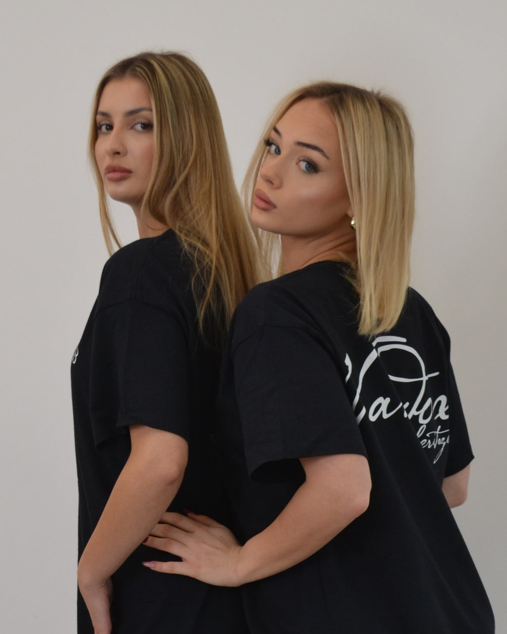 Models wearing the Noire Heritage T-Shirt in black by Vandox - an oversized luxury tee featuring the signature “Vandox Heritage” back print. A minimalist yet refined piece inspired by Parisian streetwear aesthetics, perfect for timeless everyday styling. Starboy old money shirt tshirt clothes vandox sacrevandox vandox clothes vandox clothing