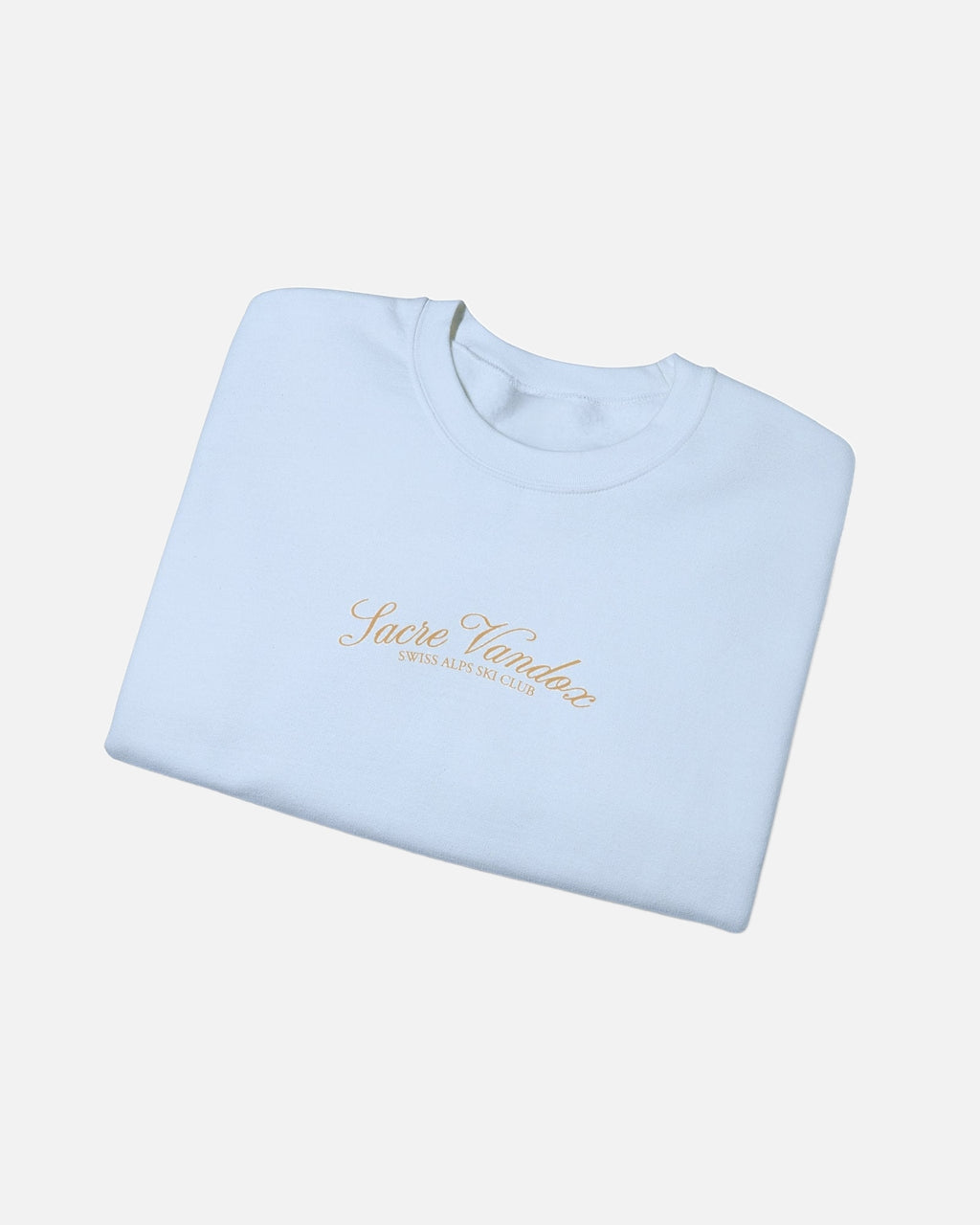 Folded view of Light Blue Vandox Chalet Edit crewneck sweatshirt with gold Sacre Vandox Swiss Alps Ski Club script chest graphic. Starboy old money hoodie sweatshirt clothes vandox sacrevandox vandox clothes vandox clothing crewneck autumn clothes no hood fall clothes 