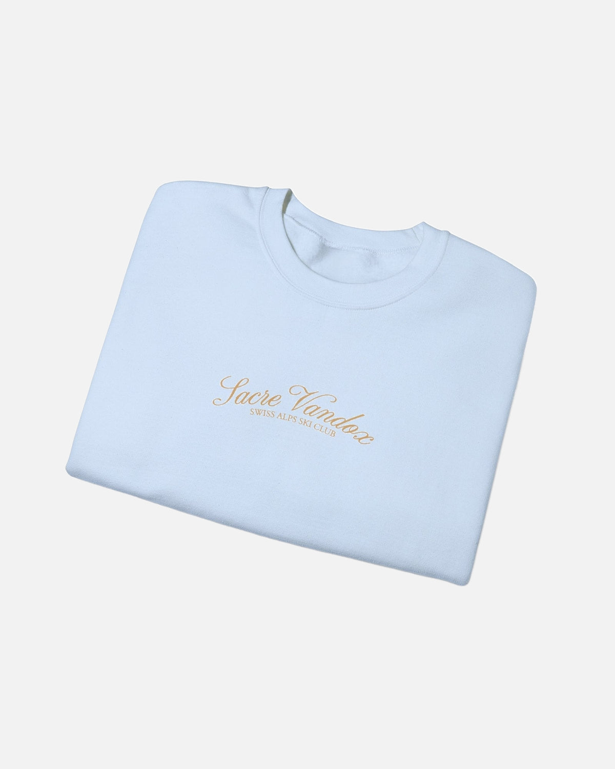 Folded view of Light Blue Vandox Chalet Edit crewneck sweatshirt with gold Sacre Vandox Swiss Alps Ski Club script chest graphic. Starboy old money hoodie sweatshirt clothes vandox sacrevandox vandox clothes vandox clothing crewneck autumn clothes no hood fall clothes 