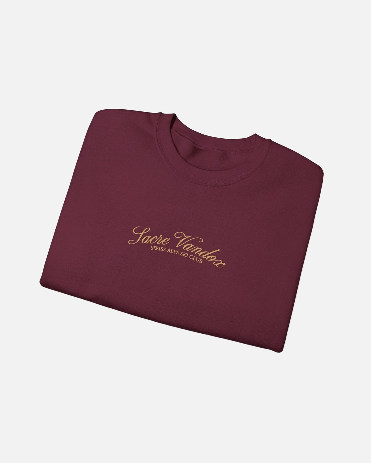 folded view of Maroon Vandox Chalet Edit crewneck sweatshirt with gold Sacre Vandox Swiss Alps Ski Club script chest graphic. Starboy old money hoodie sweatshirt clothes vandox sacrevandox vandox clothes vandox clothing crewneck autumn clothes no hood fall clothes 