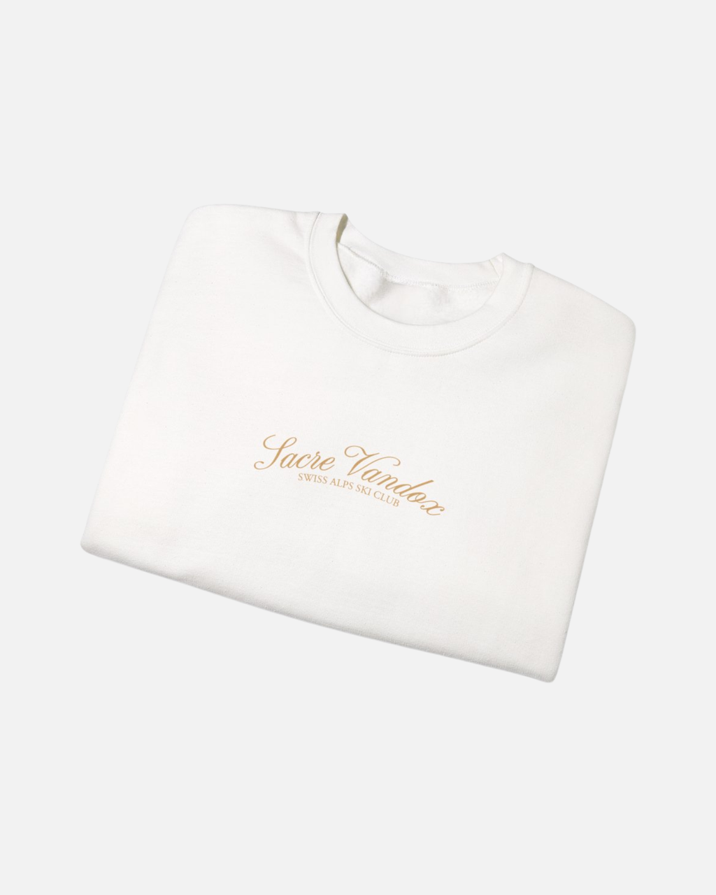 Folded view of White Vandox Chalet Edit crewneck sweatshirt with gold Sacre Vandox Swiss Alps Ski Club script chest graphic. Starboy old money hoodie sweatshirt clothes vandox sacrevandox vandox clothes vandox clothing crewneck autumn clothes no hood fall clothes 