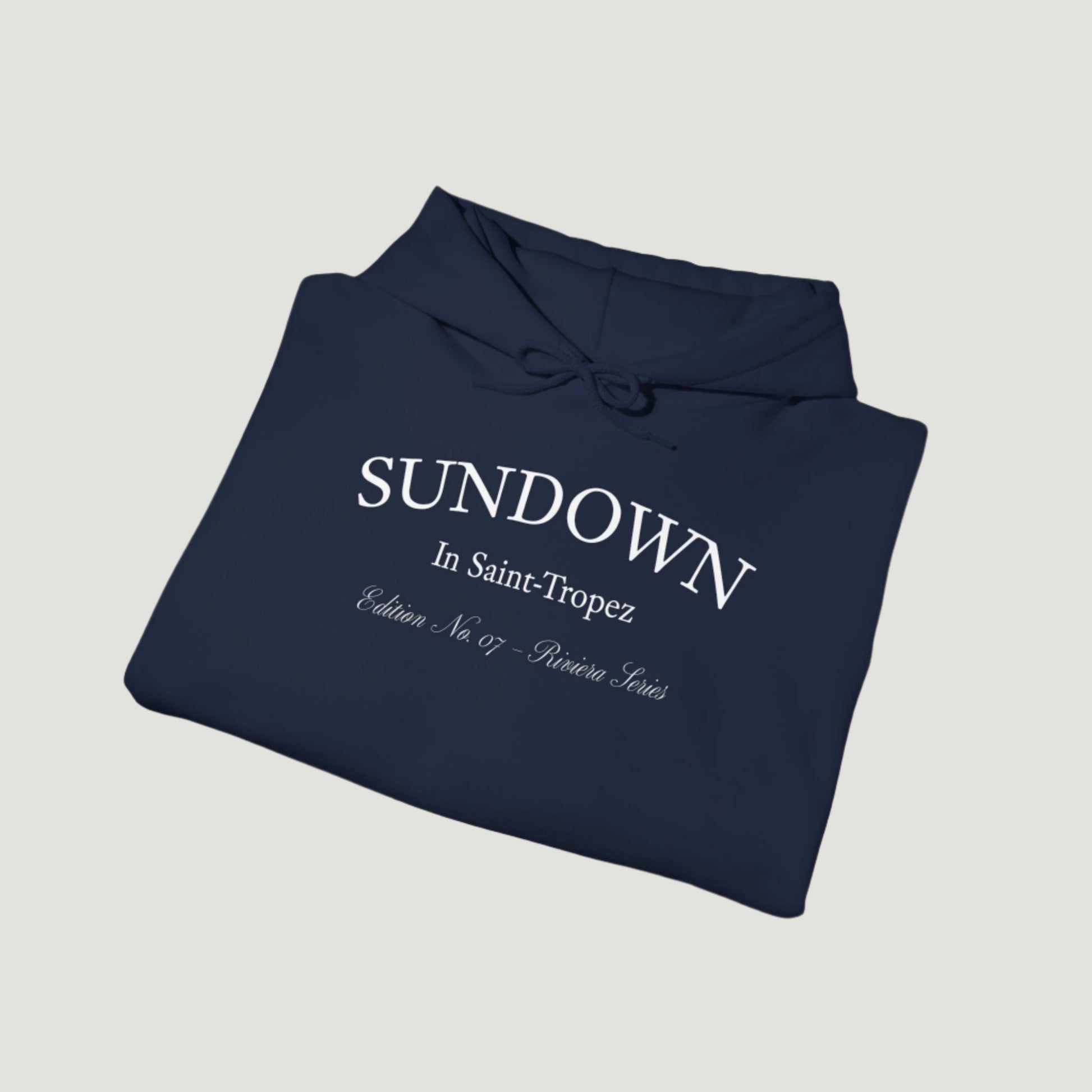 Folded view of Navy Dark Blue Citrus Sunset Hoodie featuring Saint-Tropez citrus plate graphic and Sundown script from Vandox SS25 Collection. Starboy old money hoodie sweatshirt clothes vandox sacrevandox vandox clothes vandox clothing