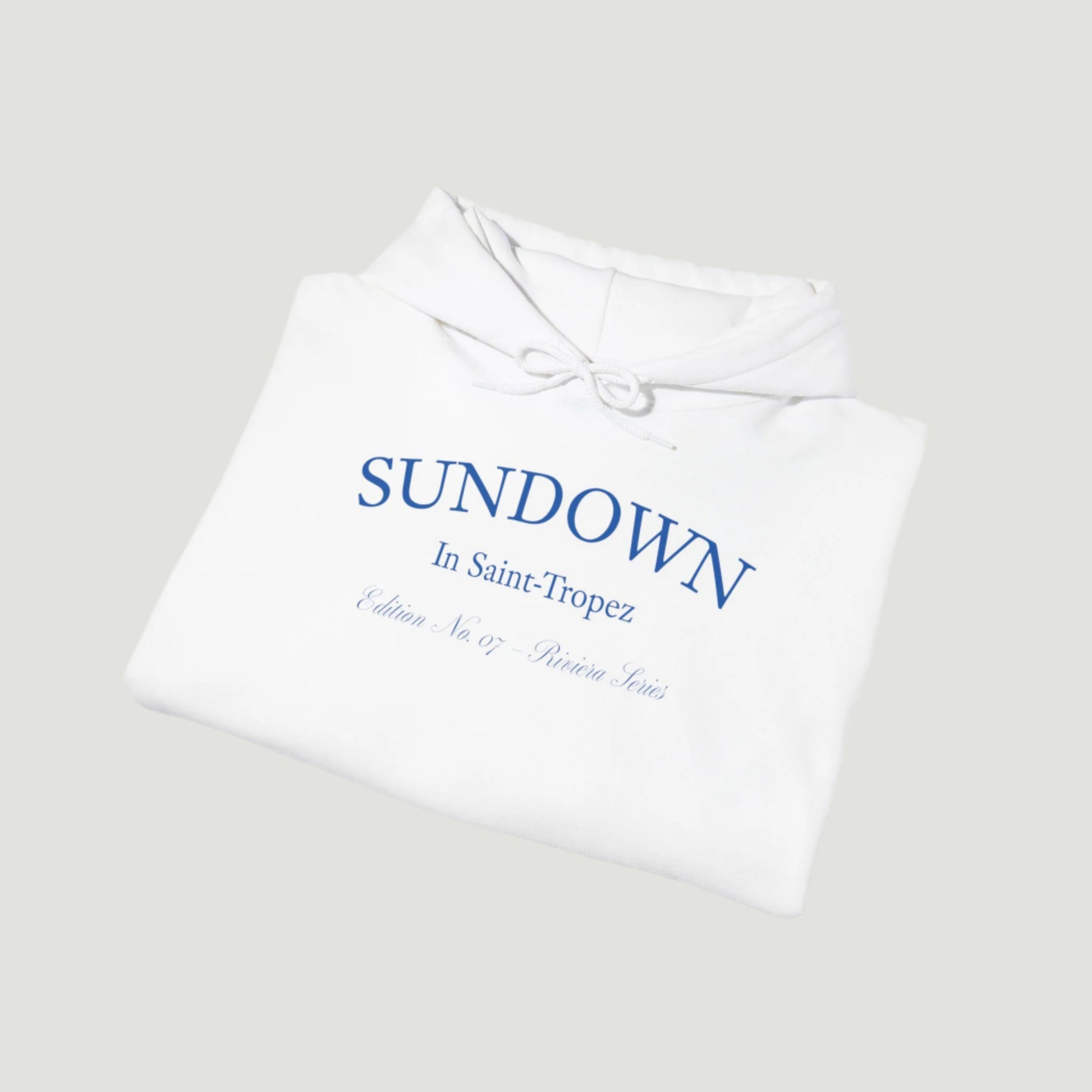 Folded view of Eggshell White Citrus Sunset Hoodie featuring Saint-Tropez citrus plate graphic and Sundown script from Vandox SS25 Collection. Starboy old money hoodie sweatshirt clothes vandox sacrevandox vandox clothes vandox clothing
