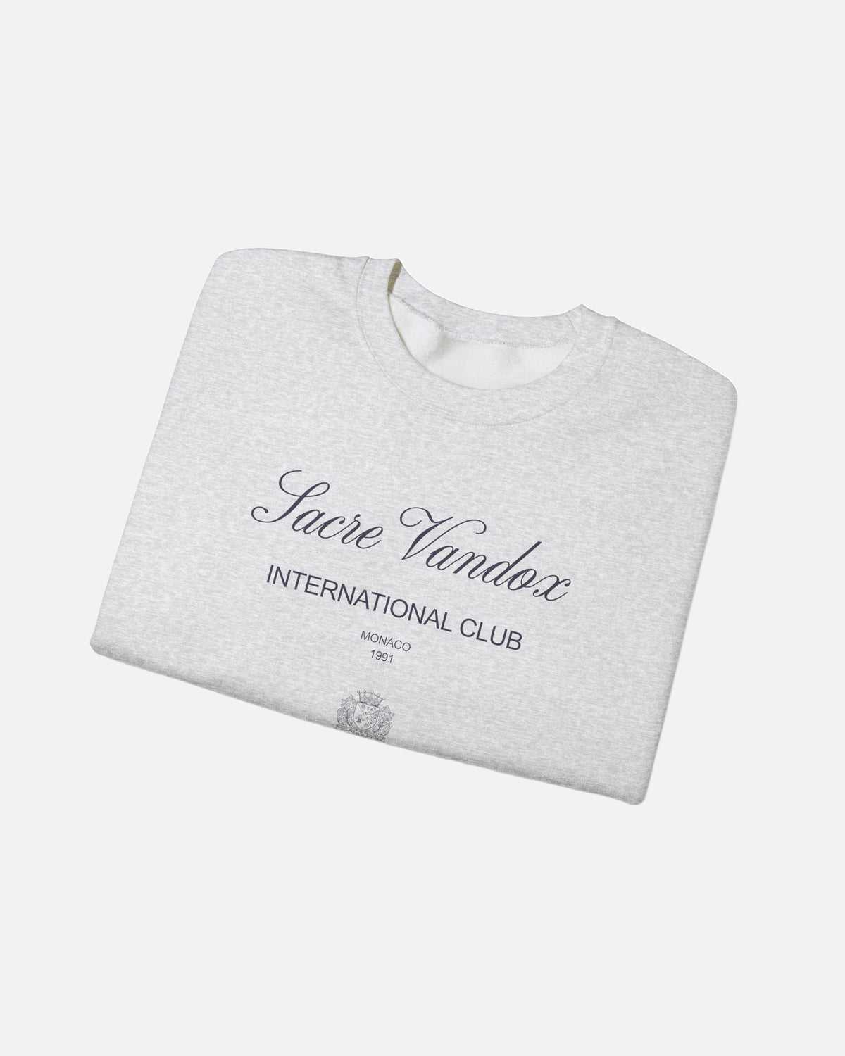 ash sport grey heather gray Vandox Le Rocher Crewneck, folded front view with Sacre Vandox script, International Club Monaco 1991 text and small crest, luxury streetwear crewneck. Starboy old money crewneck sweatshirt clothes vandox sacrevandox vandox clothes vandox clothing