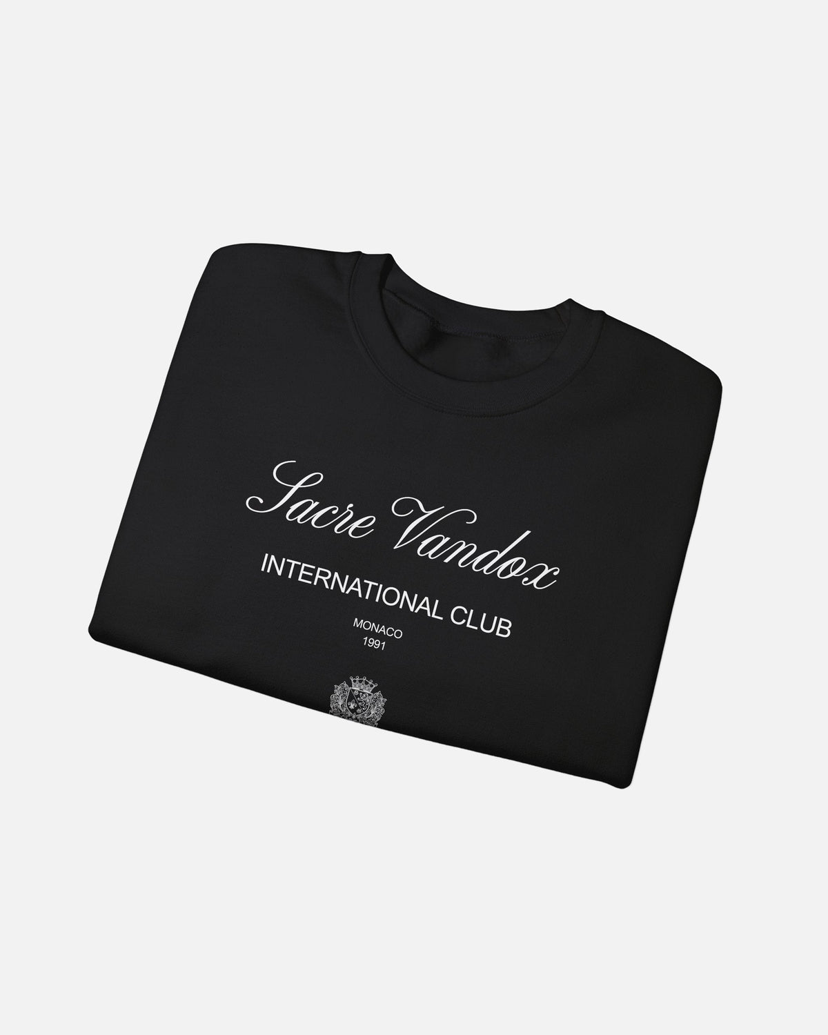 Black Vandox Le Rocher Crewneck, folded front view with Sacre Vandox script, International Club Monaco 1991 text and small crest, luxury streetwear crewneck. Starboy old money crewneck sweatshirt clothes vandox sacrevandox vandox clothes vandox clothing