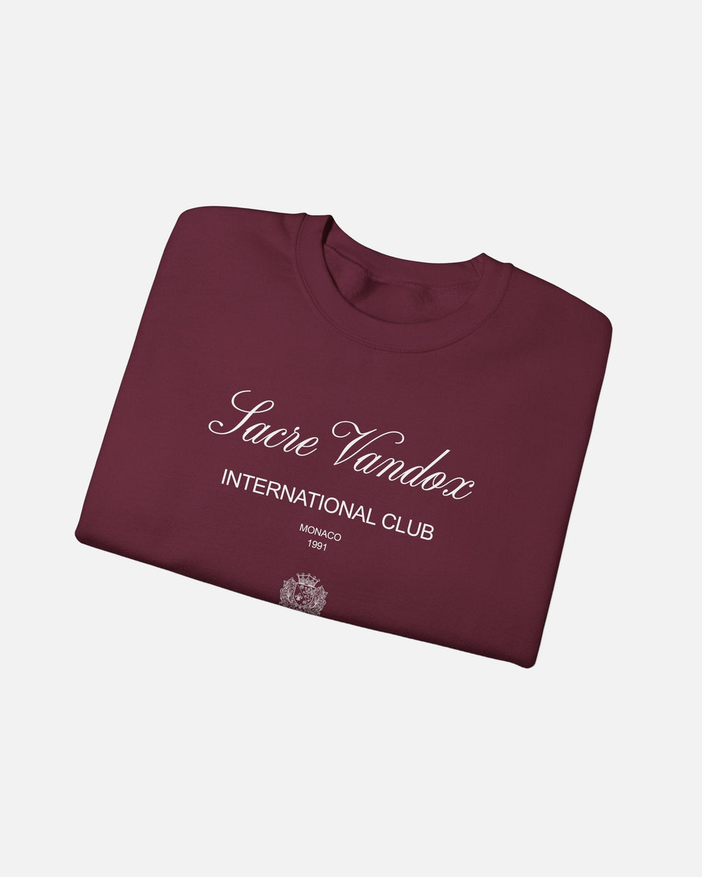maroon dark red Vandox Le Rocher Crewneck, folded front view with Sacre Vandox script, International Club Monaco 1991 text and small crest, luxury streetwear crewneck. Starboy old money crewneck sweatshirt clothes vandox sacrevandox vandox clothes vandox clothing