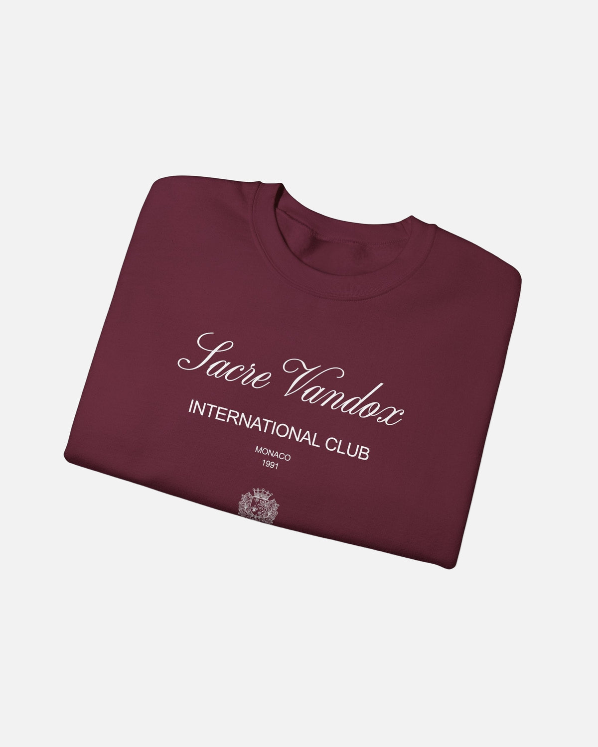 maroon dark red Vandox Le Rocher Crewneck, folded front view with Sacre Vandox script, International Club Monaco 1991 text and small crest, luxury streetwear crewneck. Starboy old money crewneck sweatshirt clothes vandox sacrevandox vandox clothes vandox clothing