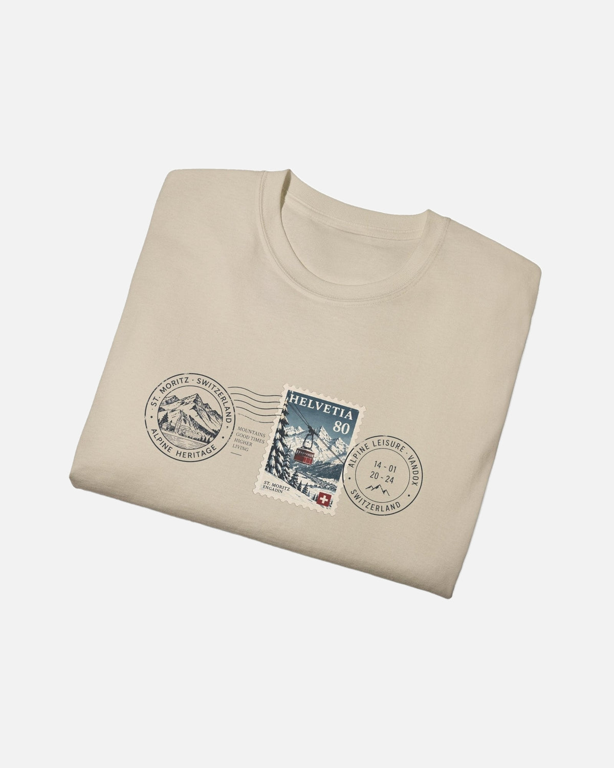 folded view of Beige Sand Cream Vandox Post Stamp t-shirt with vintage Helvetia 80 postal stamp St. Moritz Engadin scene and Alpine Heritage Alpine Leisure Vandox postmark chest graphic. Starboy old money shirt tshirt clothes vandox sacrevandox vandox clothes vandox clothing