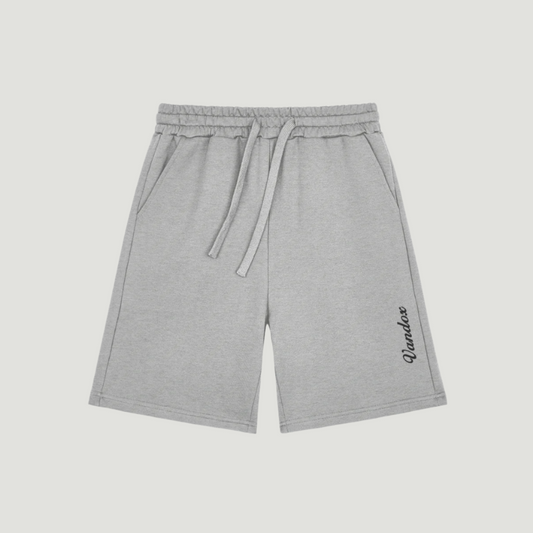 Sport Heather Grey Vandox shorts with vertical black script logo on hem, featuring drawstring waist and side pockets. Starboy old money shorts pants bottoms clothes vandox sacrevandox vandox clothes vandox clothing