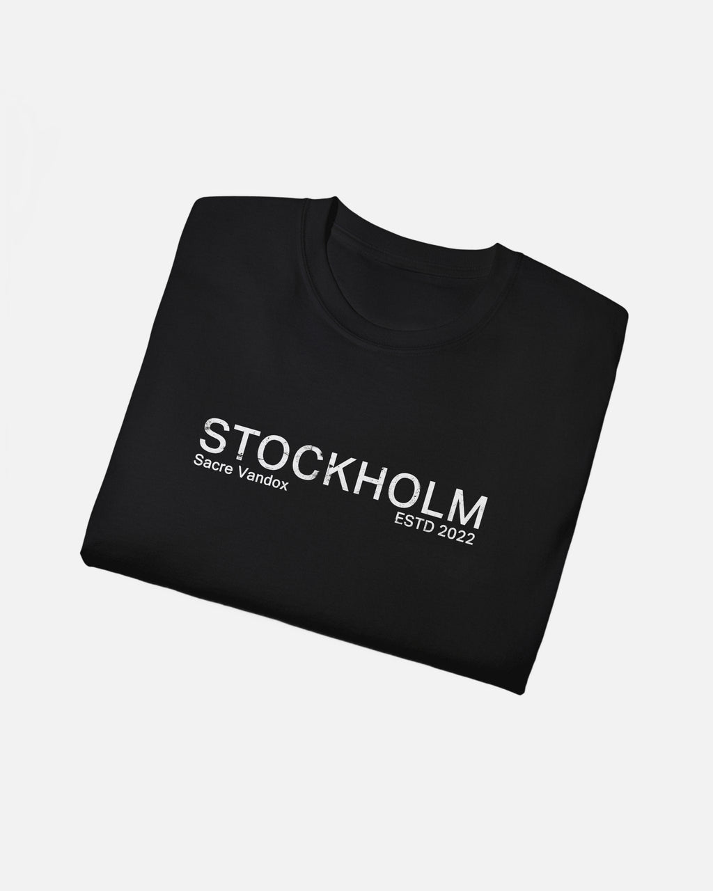 Folded view of Black Vandox Stockholm t-shirt with distressed STOCKHOLM Sacre Vandox ESTD 2022 front graphic print. Starboy old money shirt tshirt clothes vandox sacrevandox vandox clothes vandox clothing