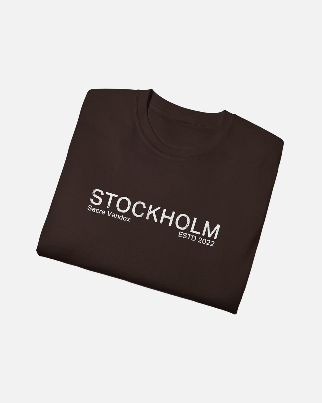 Folded view of Dark Chocolate Vandox Stockholm t-shirt with distressed STOCKHOLM Sacre Vandox ESTD 2022 front graphic print. Starboy old money shirt tshirt clothes vandox sacrevandox vandox clothes vandox clothing