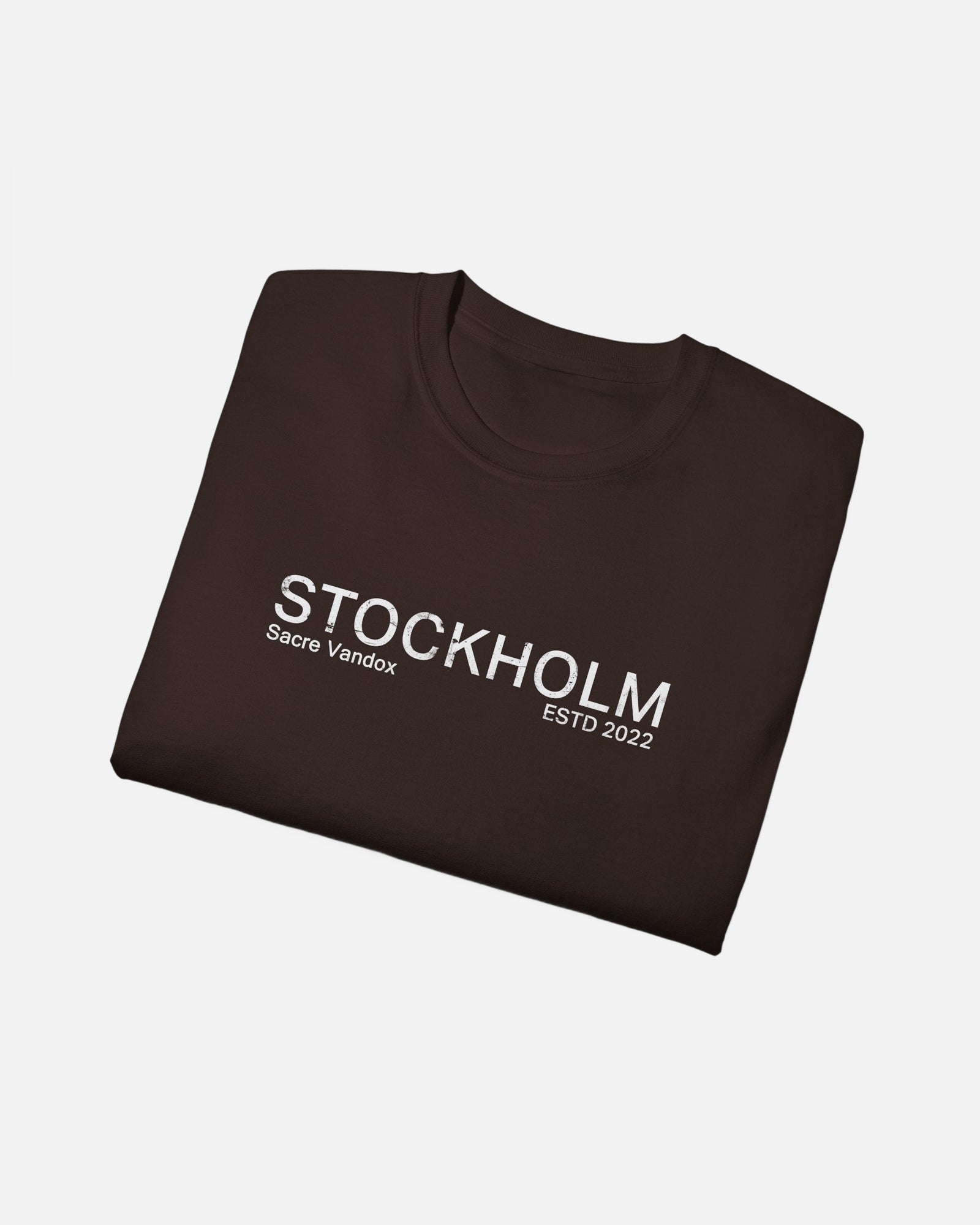 Folded view of Dark Chocolate Vandox Stockholm t-shirt with distressed STOCKHOLM Sacre Vandox ESTD 2022 front graphic print. Starboy old money shirt tshirt clothes vandox sacrevandox vandox clothes vandox clothing