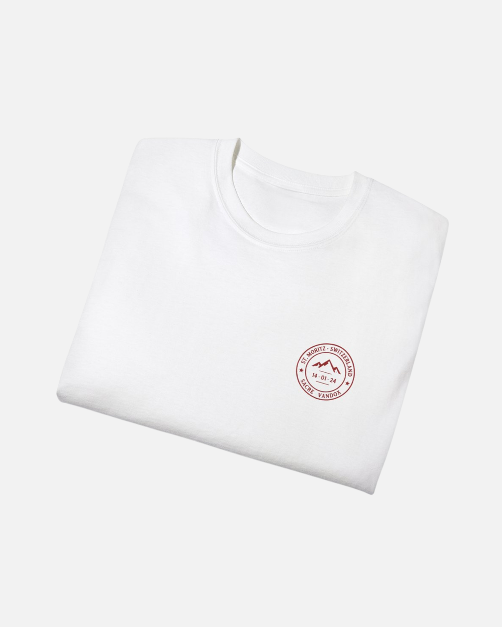 Eggshell White Vandox Powder Day t-shirt folded front view with red St. Moritz Switzerland circular stamp and Sacre Vandox chest graphic. Starboy old money shirt tshirt clothes vandox sacrevandox vandox clothes vandox clothing