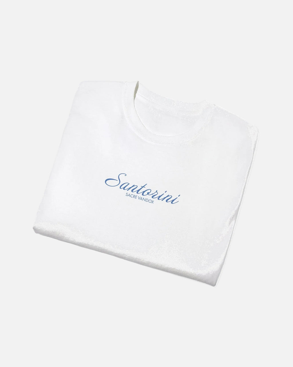 White Vandox Santorini Tee folded view – white premium cotton t-shirt with Santorini script and Sacre Vandox lettering, Postcards collection. Starboy old money shirt tshirt clothes vandox sacrevandox vandox clothes vandox clothing